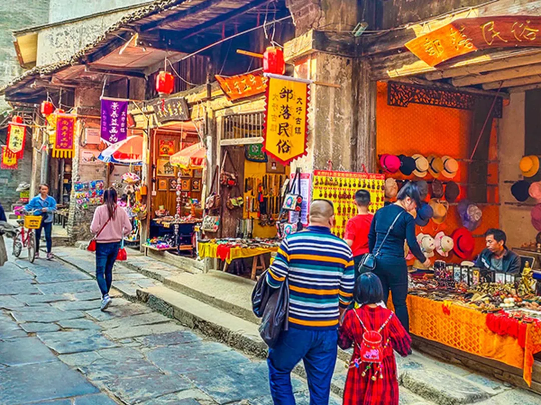 Lantern-hung old-street shopfronts and souvenir stalls in an ancient town