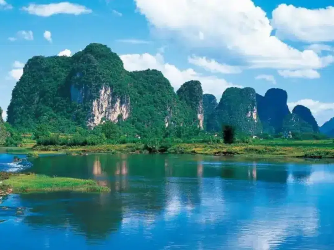 Karst peaks reflected in still water near Yangshuo
