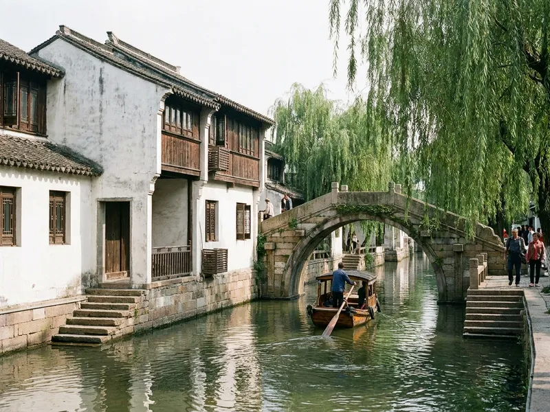 Classical Chinese garden in Suzhou with reflection in a koi pond and a moon gate in the background